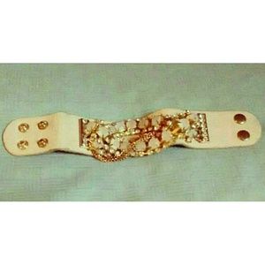 Pink imitation gemstone cuff with snap closure.